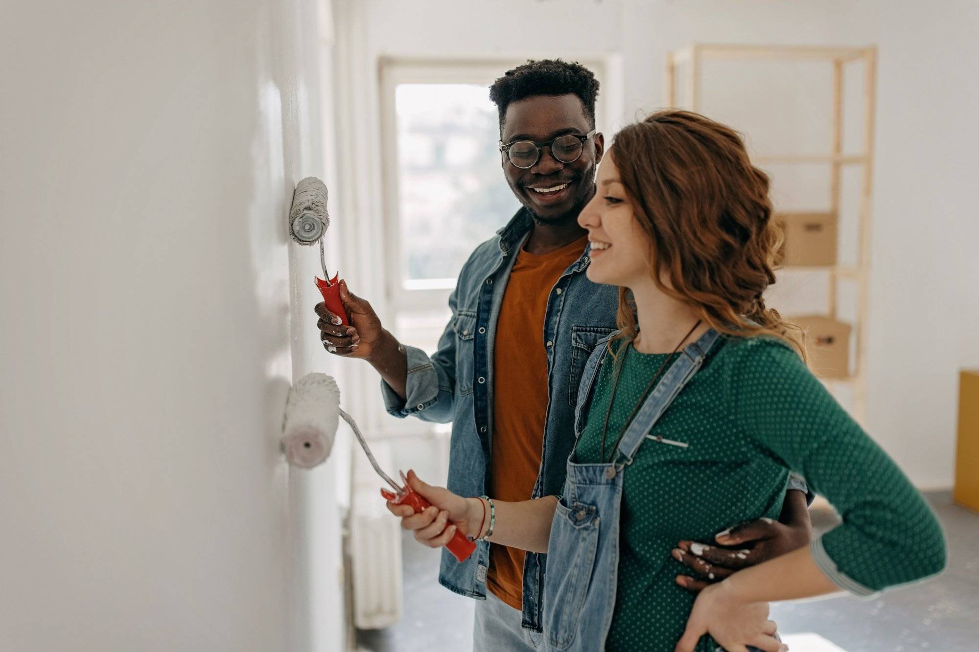 Young couple painting walls Young couple painting walls