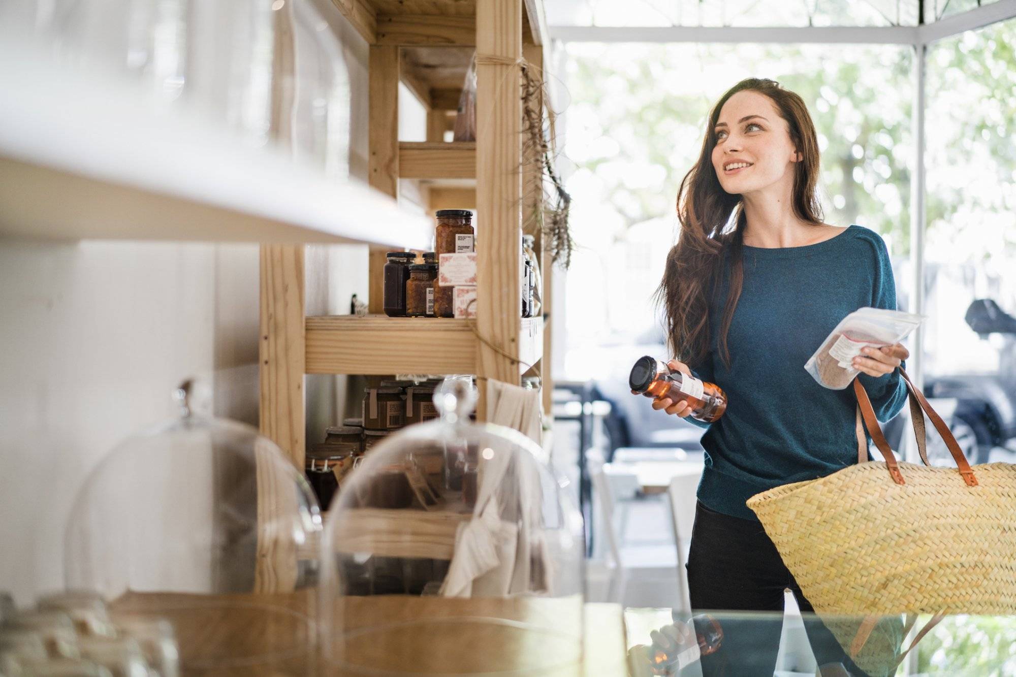 Beautiful woman choosing packets in coffee shop